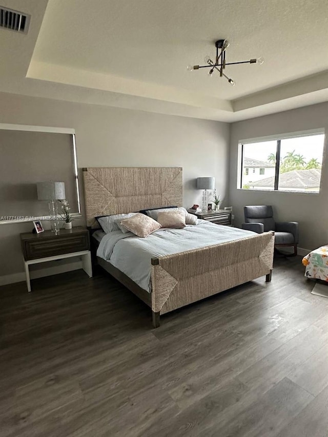 8868 NW 161st Ter, Miami Lakes, FL 33018 - bedroom featuring a tray ceiling, a chandelier, and wood finished floors
