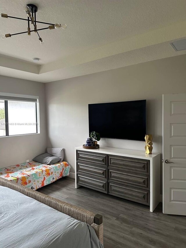 8868 NW 161st Ter, Miami Lakes, FL 33018 - bedroom featuring wood finished floors, a chandelier, and a textured ceiling