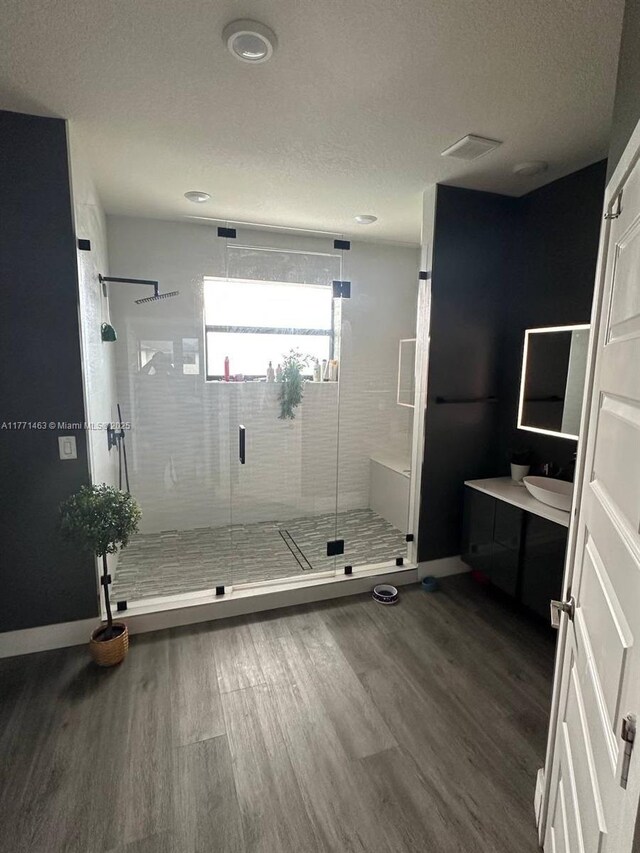 8868 NW 161st Ter, Miami Lakes, FL 33018 - full bathroom with wood finished floors, vanity, a stall shower, and a textured ceiling