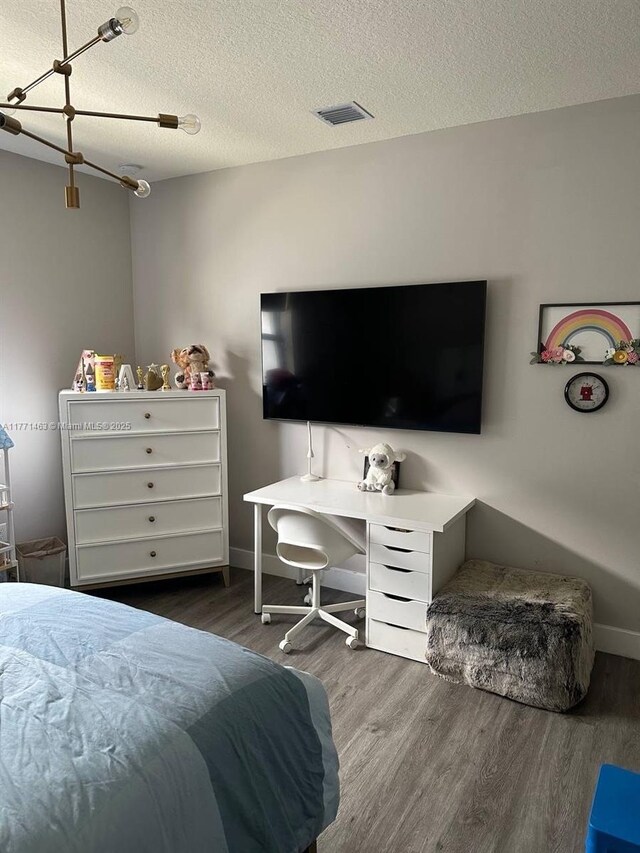 8868 NW 161st Ter, Miami Lakes, FL 33018 - bedroom featuring wood finished floors and a textured ceiling