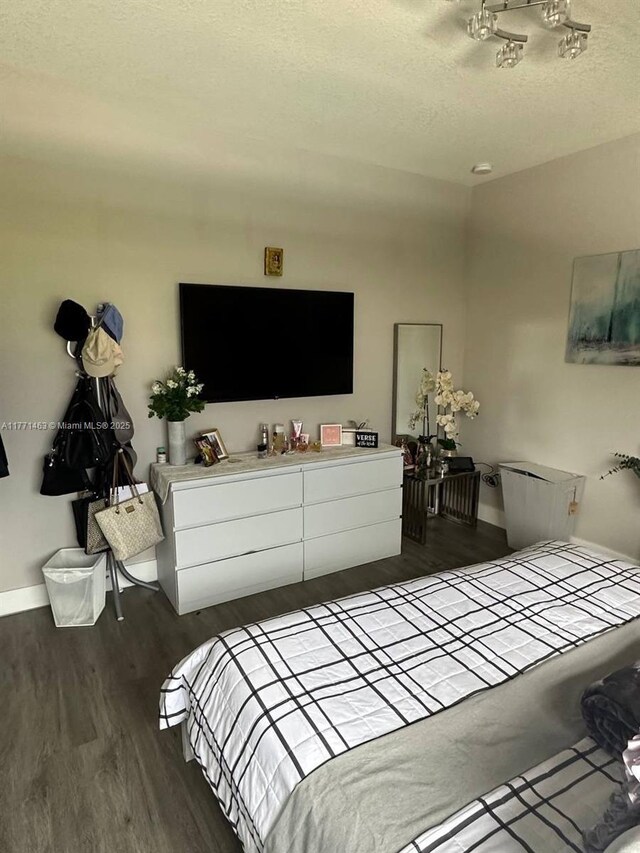 8868 NW 161st Ter, Miami Lakes, FL 33018 - bedroom with wood finished floors and a textured ceiling