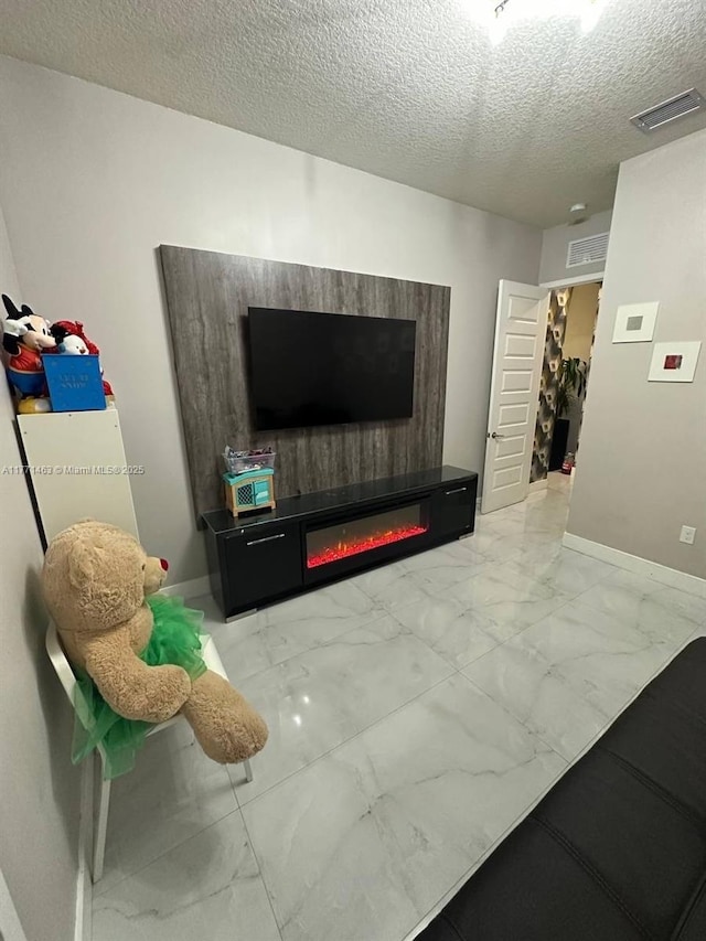 8868 NW 161st Ter, Miami Lakes, FL 33018 - living area featuring marble look tile flooring, a glass covered fireplace, and a textured ceiling