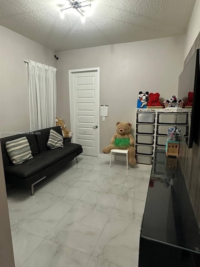8868 NW 161st Ter, Miami Lakes, FL 33018 - living room featuring marble finish flooring and a textured ceiling