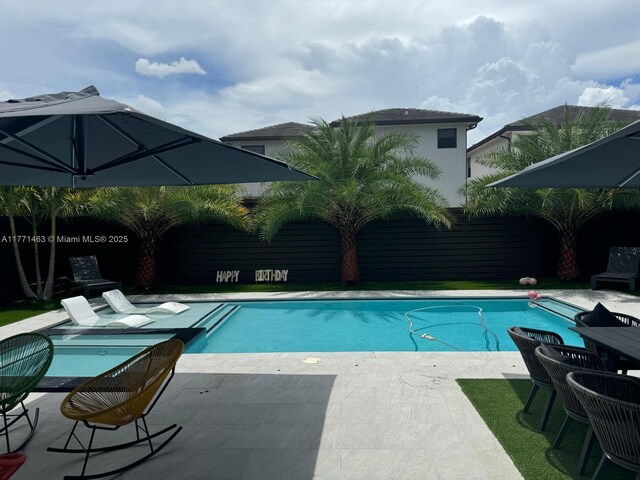 8868 NW 161st Ter, Miami Lakes, FL 33018 - swimming pool with a patio area and a fenced backyard