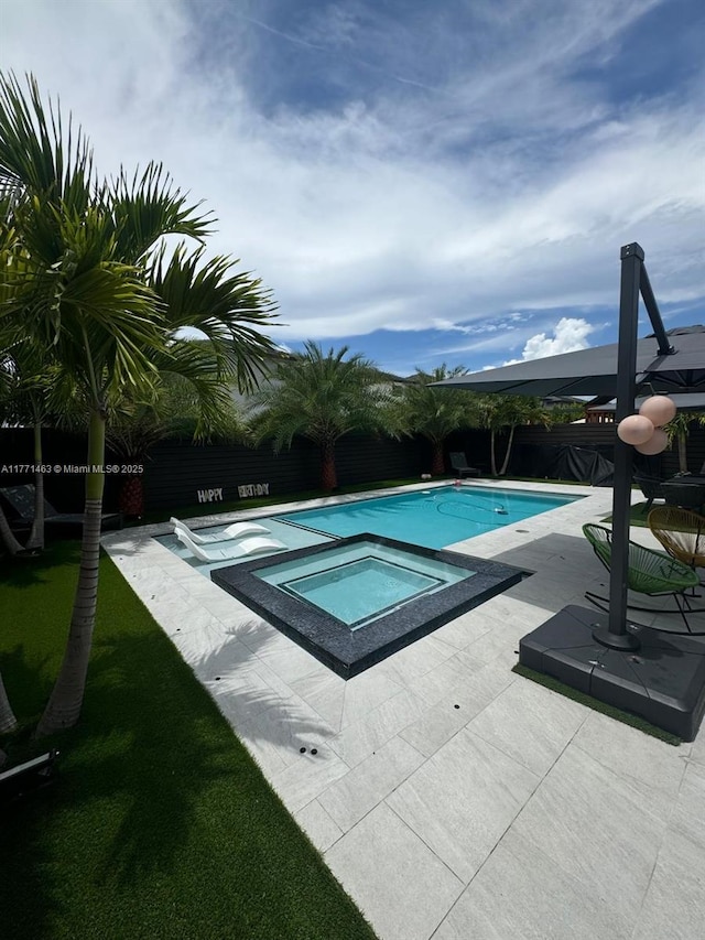 8868 NW 161st Ter, Miami Lakes, FL 33018 - view of swimming pool featuring a fenced backyard, a patio, and a pool with connected hot tub