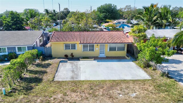 6288 SW 22nd Ct, Miramar, FL 33023 - rear view of house with a tiled roof, stucco siding, fence, and a lawn