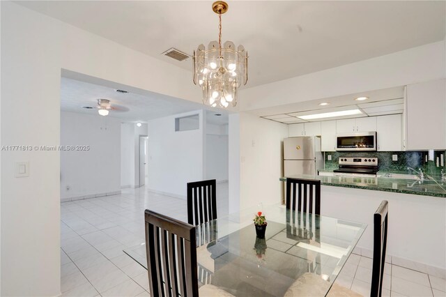 6288 SW 22nd Ct, Miramar, FL 33023 - dining room featuring light tile patterned flooring, ceiling fan with notable chandelier, and visible vents