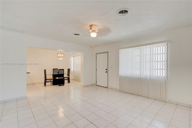 6288 SW 22nd Ct, Miramar, FL 33023 - spare room with light tile patterned floors, ceiling fan with notable chandelier, baseboards, and visible vents