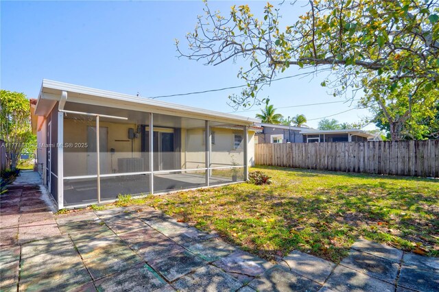 6288 SW 22nd Ct, Miramar, FL 33023 - rear view of house featuring a sunroom, fence, and a yard