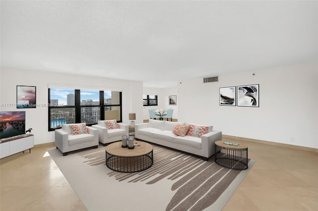 living room featuring baseboards, a view of city, and visible vents