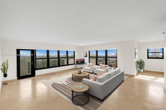 living area featuring baseboards and tile patterned flooring
