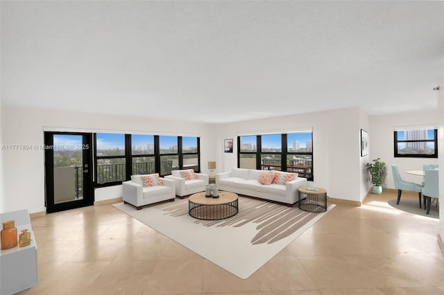 living room with baseboards and light tile patterned floors