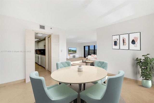 dining room featuring light tile patterned flooring, baseboards, and visible vents