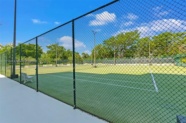 community pool with fence and a patio