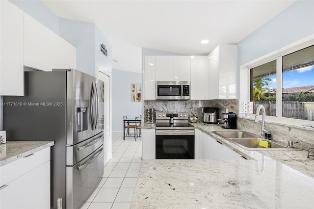15317 SW 179th Ter, Miami, FL 33187 - kitchen featuring light tile patterned flooring, a sink, tasteful backsplash, appliances with stainless steel finishes, and modern cabinets