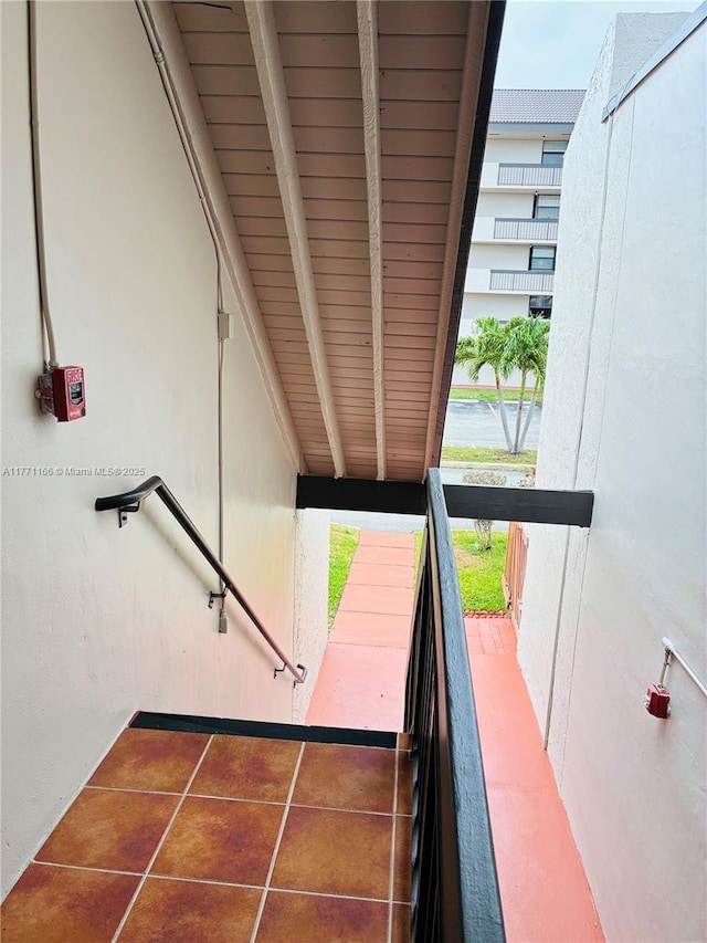 8883 Fontainebleau Blvd Unit 202, Miami, FL 33172 - staircase with beam ceiling, tile patterned floors, and wood ceiling