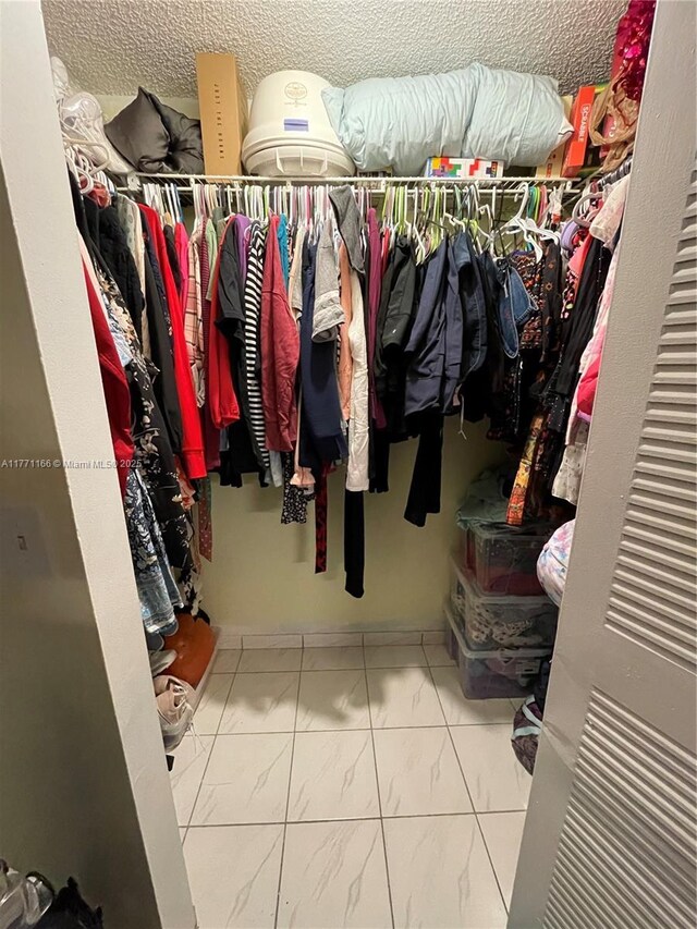 8883 Fontainebleau Blvd Unit 202, Miami, FL 33172 - walk in closet featuring marble finish flooring