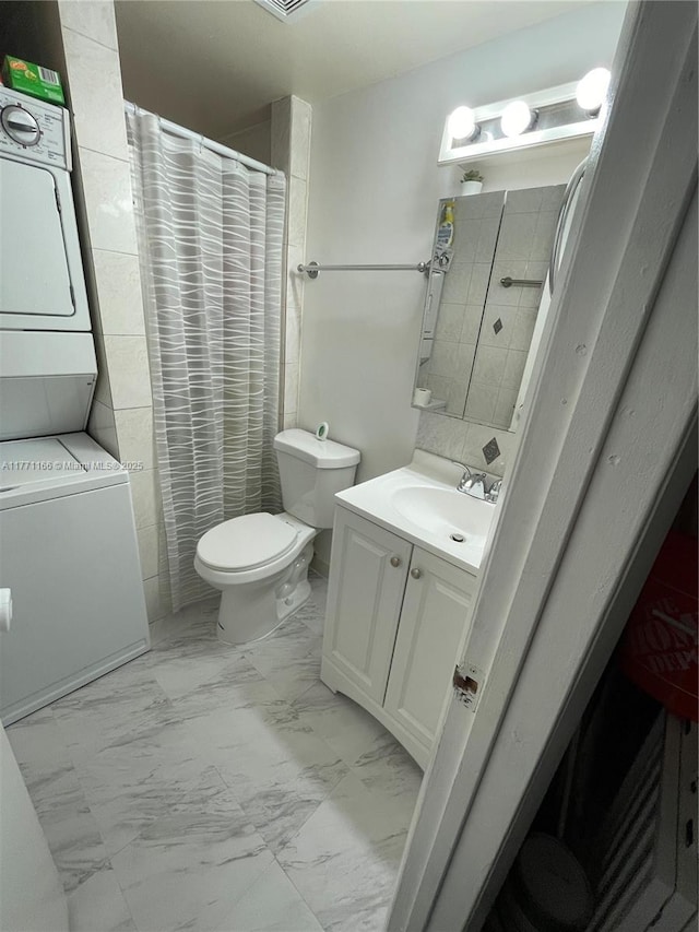 8883 Fontainebleau Blvd Unit 202, Miami, FL 33172 - full bathroom featuring stacked washer / dryer, marble look tile flooring, toilet, vanity, and curtained shower