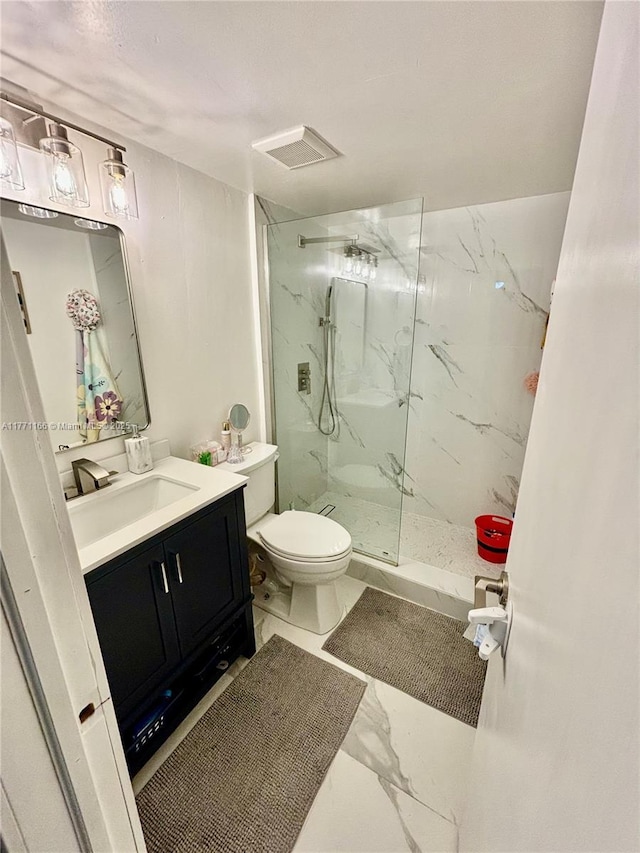 full bathroom featuring toilet, a marble finish shower, visible vents, marble finish floor, and vanity