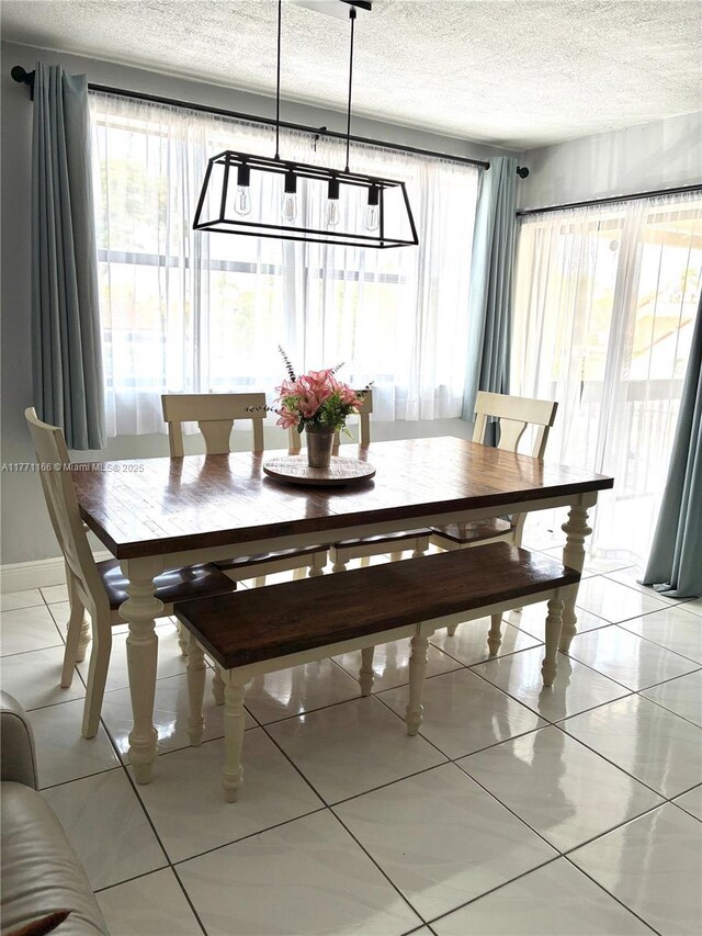 8883 Fontainebleau Blvd Unit 202, Miami, FL 33172 - dining room featuring a textured ceiling and light tile patterned flooring