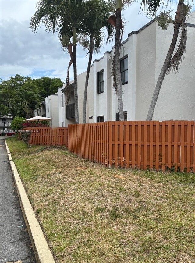 8883 Fontainebleau Blvd Unit 202, Miami, FL 33172 - view of home's exterior featuring stucco siding and fence