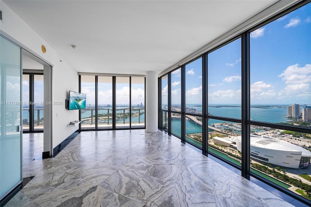 1100 Biscayne Blvd Unit 4901, Miami, FL 33132 - empty room with a wall of windows and marble tiled flooring