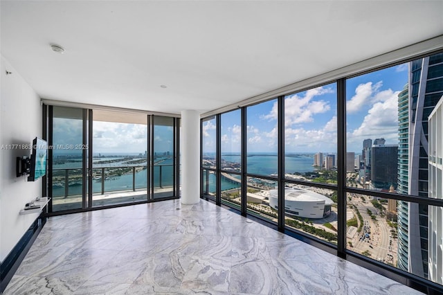 1100 Biscayne Blvd Unit 4901, Miami, FL 33132 - unfurnished room featuring a water view, a wall of windows, plenty of natural light, and marble tiled flooring