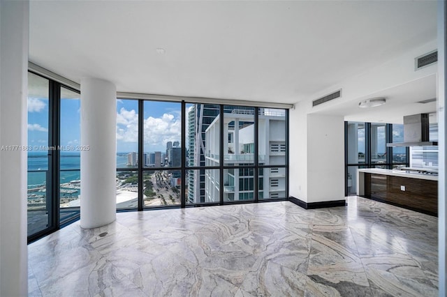 1100 Biscayne Blvd Unit 4901, Miami, FL 33132 - empty room with a wall of windows, marble tiled floors, and a water view