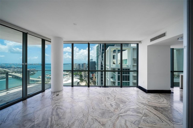 1100 Biscayne Blvd Unit 4901, Miami, FL 33132 - spare room featuring floor to ceiling windows, marble tiled flooring, a city view, and a water view