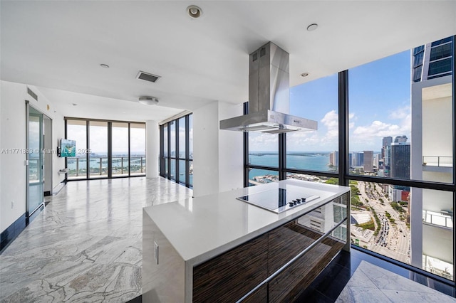 1100 Biscayne Blvd Unit 4901, Miami, FL 33132 - kitchen featuring wall chimney range hood, a wall of windows, black electric stovetop, a water view, and french doors