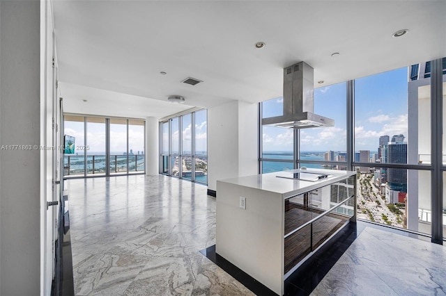 1100 Biscayne Blvd Unit 4901, Miami, FL 33132 - kitchen featuring ventilation hood, a wall of windows, marble tiled floors, electric cooktop, and a water view
