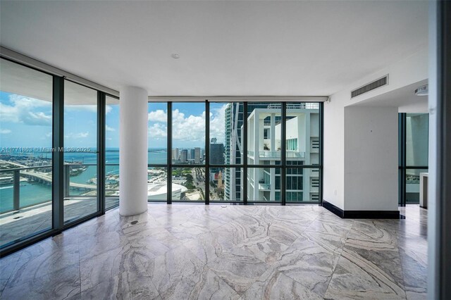 1100 Biscayne Blvd Unit 4901, Miami, FL 33132 - empty room with floor to ceiling windows, a view of city, a water view, and marble finish flooring