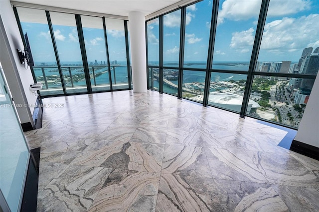 1100 Biscayne Blvd Unit 4901, Miami, FL 33132 - unfurnished room with expansive windows, a water view, healthy amount of natural light, and a view of city