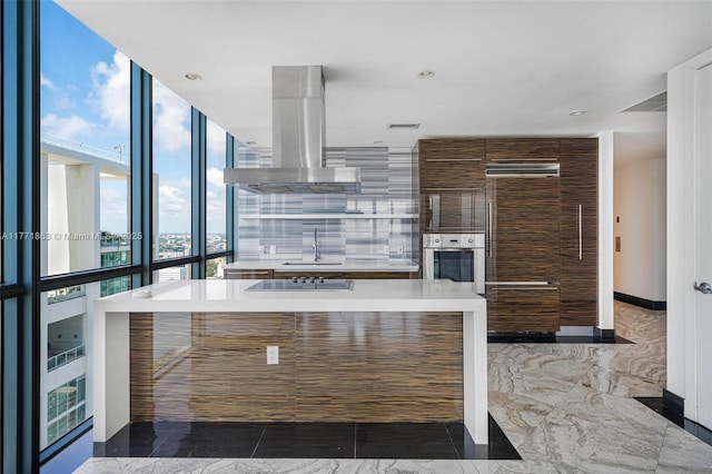 1100 Biscayne Blvd Unit 4901, Miami, FL 33132 - kitchen with island range hood, oven, modern cabinets, light countertops, and black electric cooktop