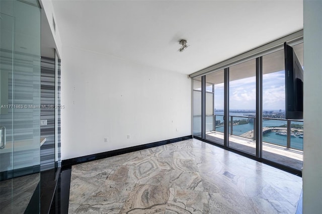 1100 Biscayne Blvd Unit 4901, Miami, FL 33132 - spare room with expansive windows, a water view, and marble finish floors