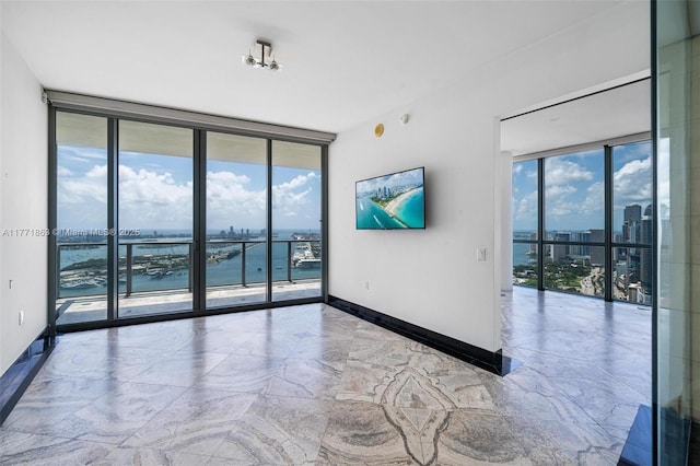 1100 Biscayne Blvd Unit 4901, Miami, FL 33132 - unfurnished room with a wall of windows and baseboards