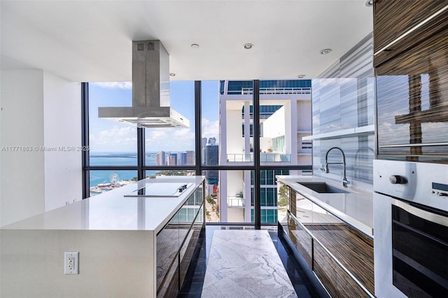 1100 Biscayne Blvd Unit 4901, Miami, FL 33132 - kitchen with stainless steel oven, island exhaust hood, expansive windows, plenty of natural light, and black electric cooktop