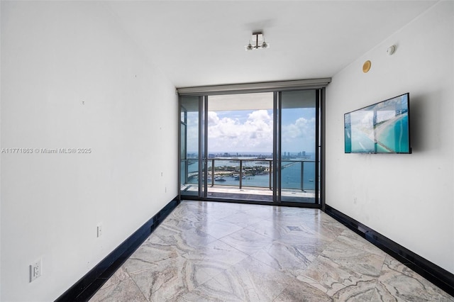 1100 Biscayne Blvd Unit 4901, Miami, FL 33132 - unfurnished room with floor to ceiling windows, marble tiled flooring, and a smoke detector
