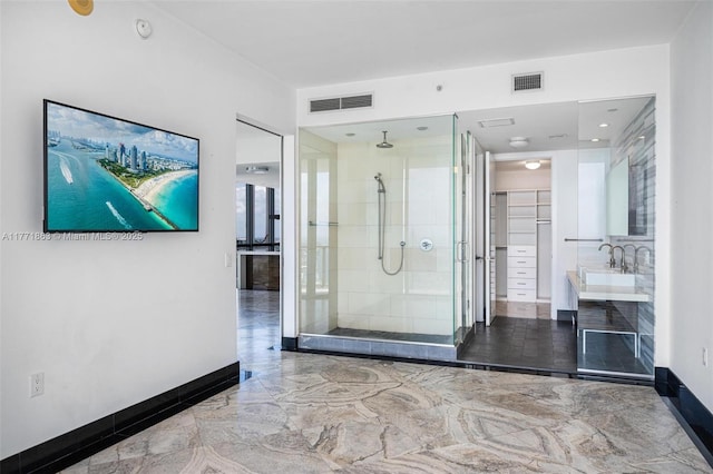 1100 Biscayne Blvd Unit 4901, Miami, FL 33132 - bathroom featuring a shower stall, marble tiled flooring, vanity, and a walk in closet