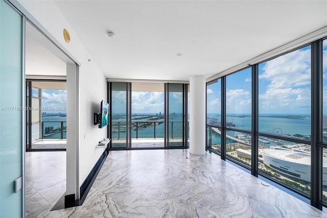1100 Biscayne Blvd Unit 4901, Miami, FL 33132 - empty room with a wall of windows, plenty of natural light, marble tiled floors, and a smoke detector