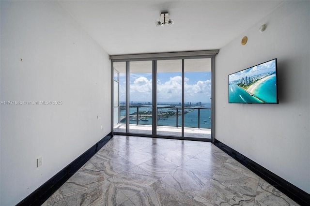 1100 Biscayne Blvd Unit 4901, Miami, FL 33132 - empty room featuring floor to ceiling windows and baseboards