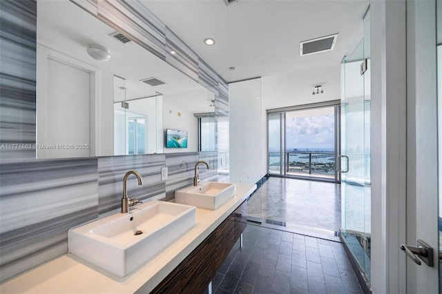 1100 Biscayne Blvd Unit 4901, Miami, FL 33132 - full bathroom featuring double vanity, tasteful backsplash, brick patterned flooring, and a stall shower