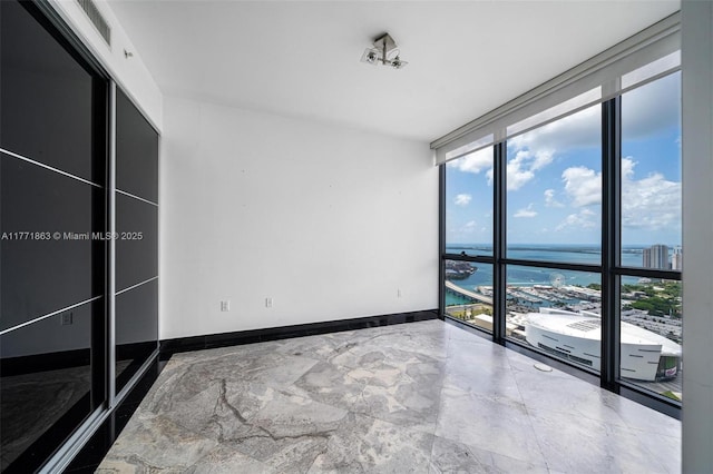 1100 Biscayne Blvd Unit 4901, Miami, FL 33132 - unfurnished bedroom featuring a water view, expansive windows, and multiple windows