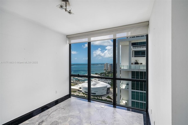 1100 Biscayne Blvd Unit 4901, Miami, FL 33132 - unfurnished room featuring floor to ceiling windows, a water view, and marble finish flooring