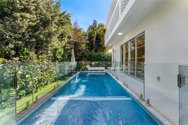 view of swimming pool with fence and a fenced in pool