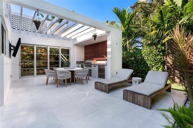 view of patio / terrace featuring area for grilling, outdoor dining space, an outdoor kitchen, and a pergola
