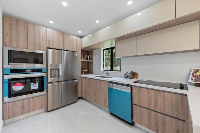 475 NW 87th St, El Portal, FL 33150 - kitchen with stainless steel appliances, a sink, modern cabinets, light countertops, and recessed lighting