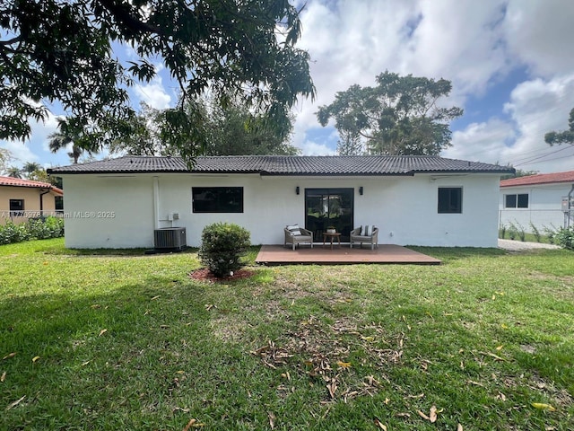 475 NW 87th St, El Portal, FL 33150 - back of house featuring a wooden deck, stucco siding, and central air condition unit