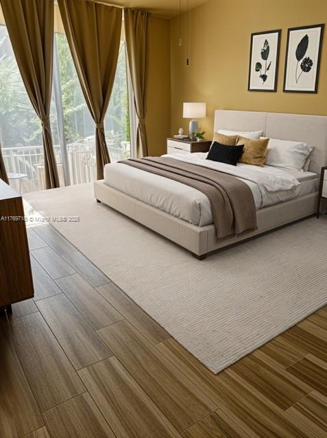3001 NE 185th St Unit 418, Aventura, FL 33180 - bedroom with access to exterior and wood finished floors