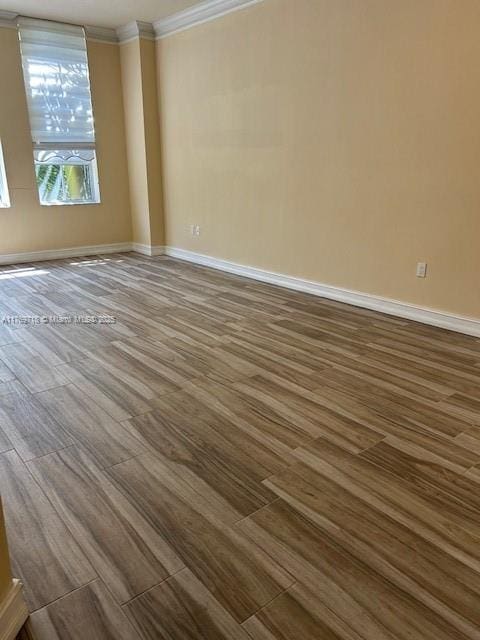 3001 NE 185th St Unit 418, Aventura, FL 33180 - spare room with dark wood-style floors, ornamental molding, and baseboards